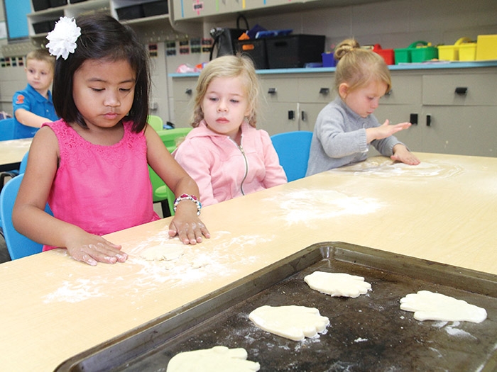 <b>First week of school</b> Classes started in the Southeast Cornerstone School Division last Tuesday. At left are MacLeod Elementary School Kindergarten students Jaeden, Evann and Kaydence making kissing hand cookies on their third day of class after reading a story called The Kissing Hand in Mrs. McMullens class.